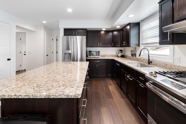 5 Fairview Ave, Auburn, ME 04210 - kitchen with appliances with stainless steel finishes, dark wood-style floors, light stone countertops, a kitchen island, and recessed lighting