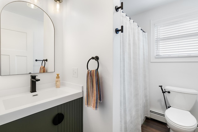 5 Fairview Ave, Auburn, ME 04210 - full bath featuring a baseboard heating unit, vanity, a shower with shower curtain, and wood finished floors