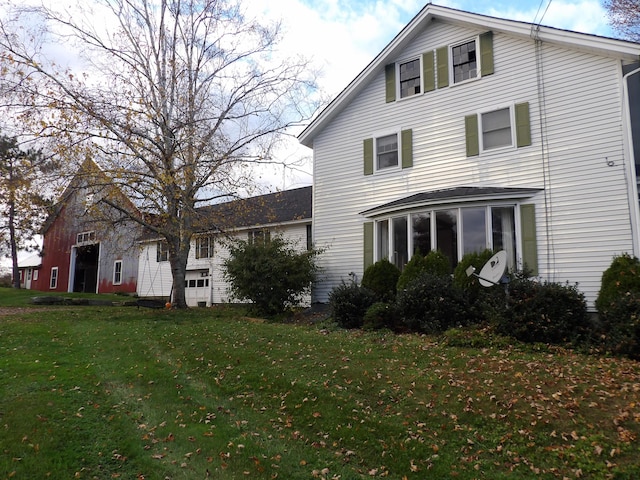 38 Atkinson Rd, Charleston, ME 04422 - view of side of home featuring a sunroom and a yard