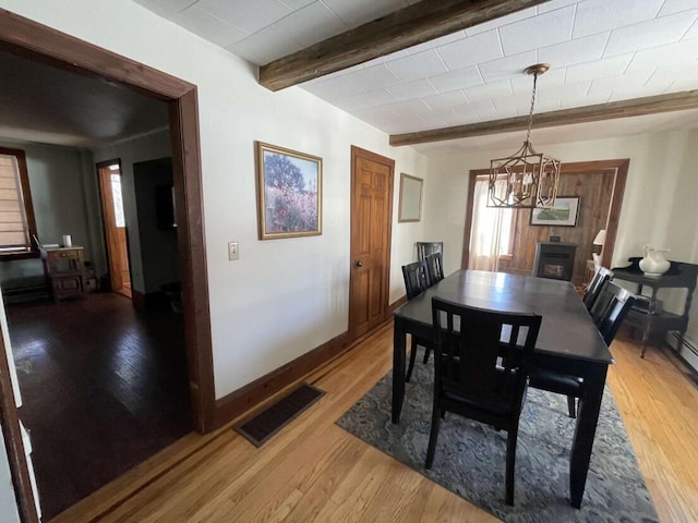 38 Atkinson Rd, Charleston, ME 04422 - dining space with a chandelier, light wood-style flooring, and beam ceiling
