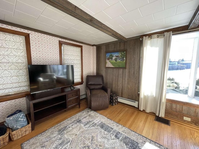 38 Atkinson Rd, Charleston, ME 04422 - living area featuring baseboard heating, hardwood / wood-style floors, a baseboard heating unit, and wallpapered walls