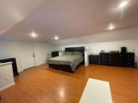 38 Atkinson Rd, Charleston, ME 04422 - bedroom featuring wood finished floors, vaulted ceiling, and recessed lighting