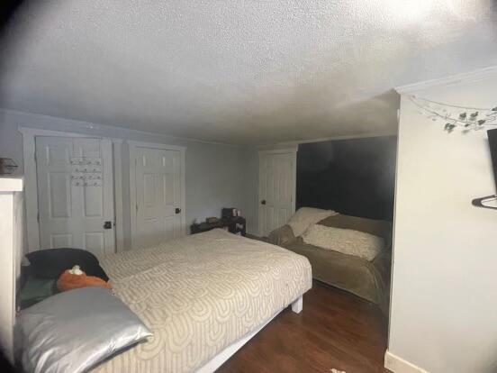 38 Atkinson Rd, Charleston, ME 04422 - bedroom featuring dark wood-style floors and a textured ceiling