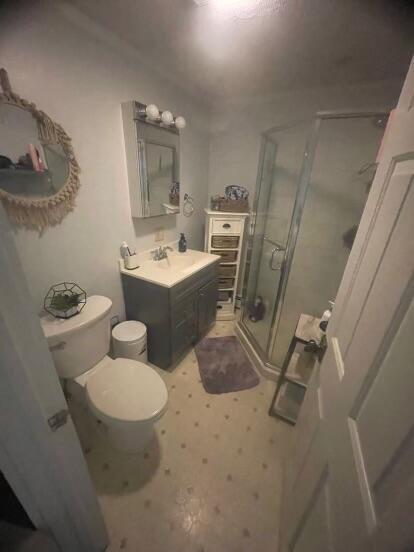 38 Atkinson Rd, Charleston, ME 04422 - bathroom with a shower stall, vanity, and tile patterned floors