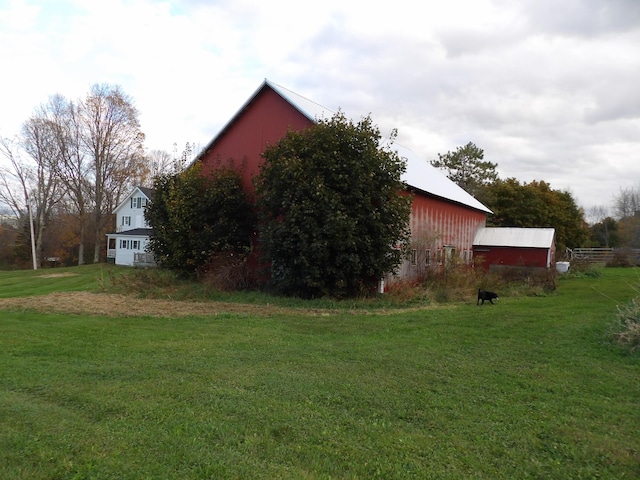 38 Atkinson Rd, Charleston, ME 04422 - view of property exterior featuring a lawn