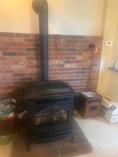 38 Atkinson Rd, Charleston, ME 04422 - detailed view of a wood stove and brick wall