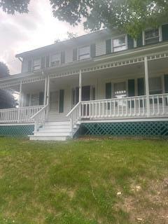 38 Atkinson Rd, Charleston, ME 04422 - view of front of house with covered porch and a front yard