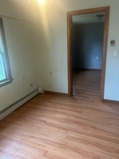 38 Atkinson Rd, Charleston, ME 04422 - empty room featuring light wood-type flooring and a baseboard heating unit