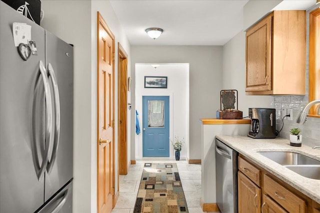 21 Bowling Green Ln, Belfast, ME 04915 - kitchen featuring appliances with stainless steel finishes, backsplash, light stone countertops, and light tile patterned flooring