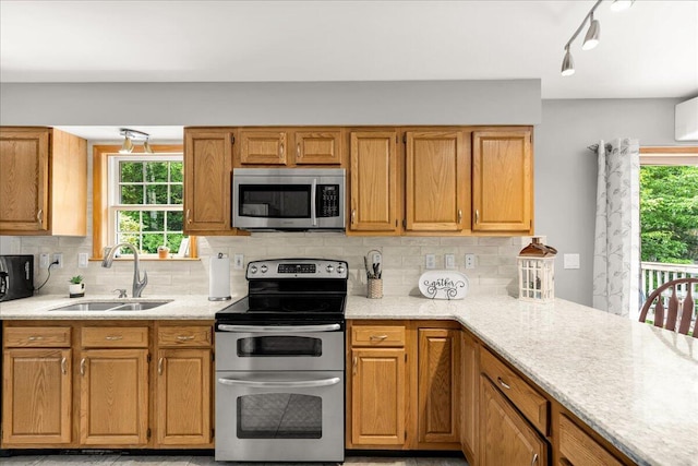 21 Bowling Green Ln, Belfast, ME 04915 - kitchen with appliances with stainless steel finishes, healthy amount of natural light, tasteful backsplash, and light stone counters
