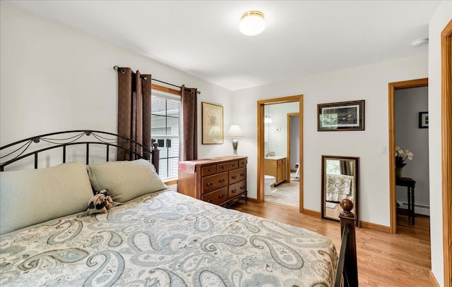 21 Bowling Green Ln, Belfast, ME 04915 - bedroom with a baseboard radiator, light wood finished floors, and connected bathroom