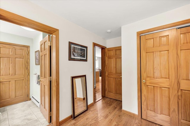 21 Bowling Green Ln, Belfast, ME 04915 - corridor featuring a baseboard radiator and light wood-type flooring