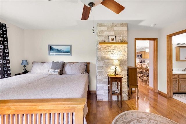 21 Bowling Green Ln, Belfast, ME 04915 - bedroom with light wood-style flooring, ensuite bathroom, and ceiling fan