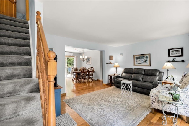 21 Bowling Green Ln, Belfast, ME 04915 - living area with stairway, wood finished floors, a chandelier, and a wall unit AC