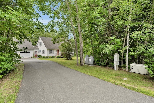 21 Bowling Green Ln, Belfast, ME 04915 - view of front of home with asphalt driveway, a front lawn, and an attached garage