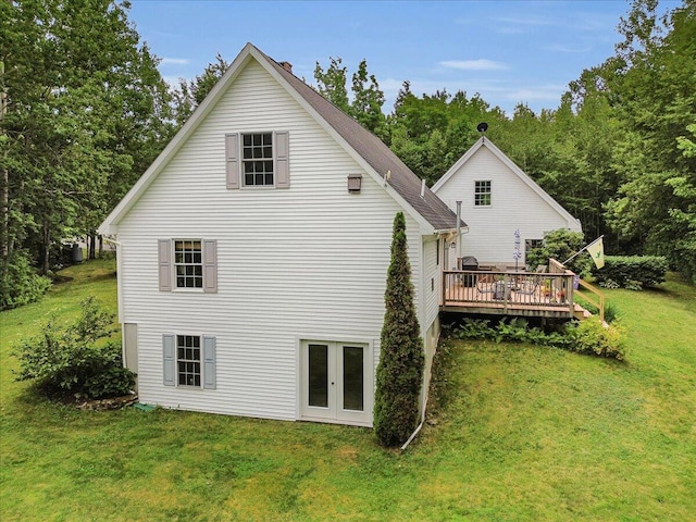 21 Bowling Green Ln, Belfast, ME 04915 - rear view of property featuring a deck, a lawn, and a chimney