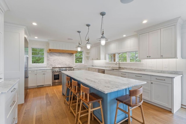 17 Intervale Rd, York, ME 03902 - kitchen featuring premium appliances, a breakfast bar area, tasteful backsplash, light wood-style flooring, and recessed lighting
