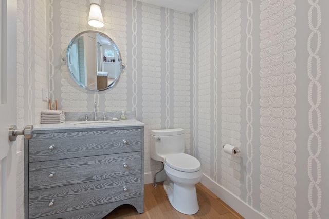 17 Intervale Rd, York, ME 03902 - half bathroom with wood finished floors, wallpapered walls, and vanity