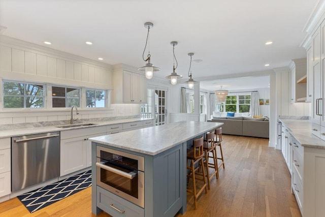 17 Intervale Rd, York, ME 03902 - kitchen with dishwasher, a kitchen breakfast bar, light wood-type flooring, white cabinets, and a kitchen island