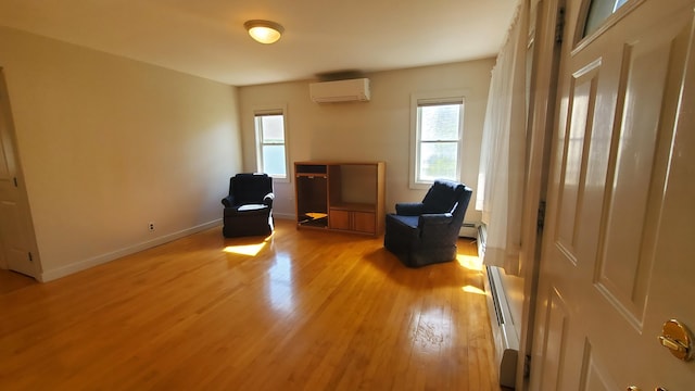 9 Wood St, Bangor, ME 04401 - living area featuring a wall mounted air conditioner, plenty of natural light, light wood finished floors, and a baseboard heating unit