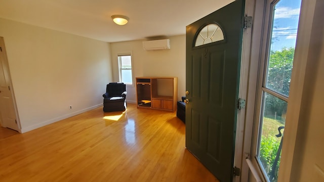 9 Wood St, Bangor, ME 04401 - entrance foyer with a wall unit AC and light wood-type flooring