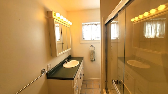 9 Wood St, Bangor, ME 04401 - bathroom featuring vanity, tile patterned flooring, and a shower with door