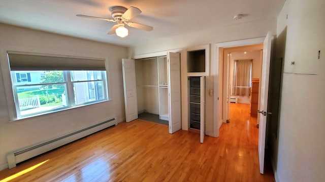 9 Wood St, Bangor, ME 04401 - unfurnished bedroom with a baseboard heating unit, light wood finished floors, a closet, and ceiling fan