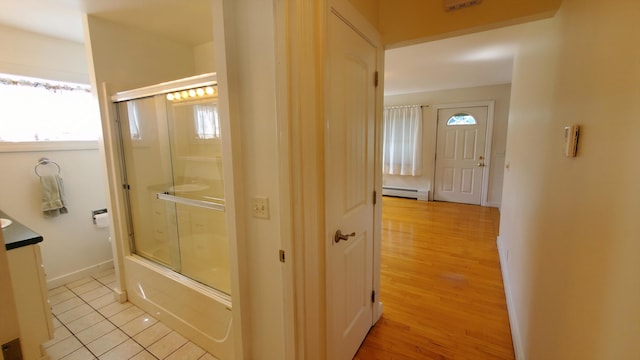 9 Wood St, Bangor, ME 04401 - full bath with plenty of natural light, a baseboard radiator, vanity, and enclosed tub / shower combo