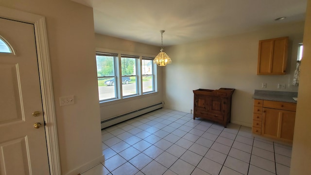 9 Wood St, Bangor, ME 04401 - unfurnished dining area with a baseboard radiator, a chandelier, and light tile patterned floors