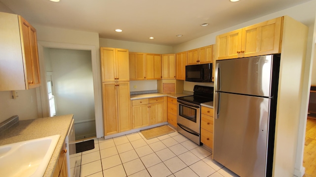 9 Wood St, Bangor, ME 04401 - kitchen with stainless steel appliances, light brown cabinets, light countertops, recessed lighting, and light tile patterned flooring