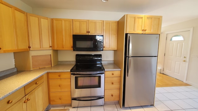9 Wood St, Bangor, ME 04401 - kitchen with stainless steel appliances, light brown cabinetry, light countertops, and light tile patterned flooring