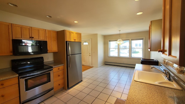 9 Wood St, Bangor, ME 04401 - kitchen featuring appliances with stainless steel finishes, a baseboard heating unit, light tile patterned flooring, recessed lighting, and light countertops