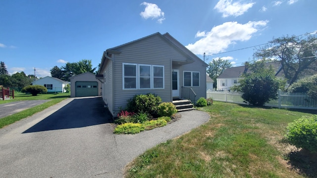 9 Wood St, Bangor, ME 04401 - bungalow-style home with asphalt driveway, an outdoor structure, and a detached garage