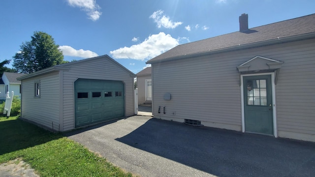 9 Wood St, Bangor, ME 04401 - view of property exterior with an outbuilding, driveway, a chimney, a garage, and roof with shingles