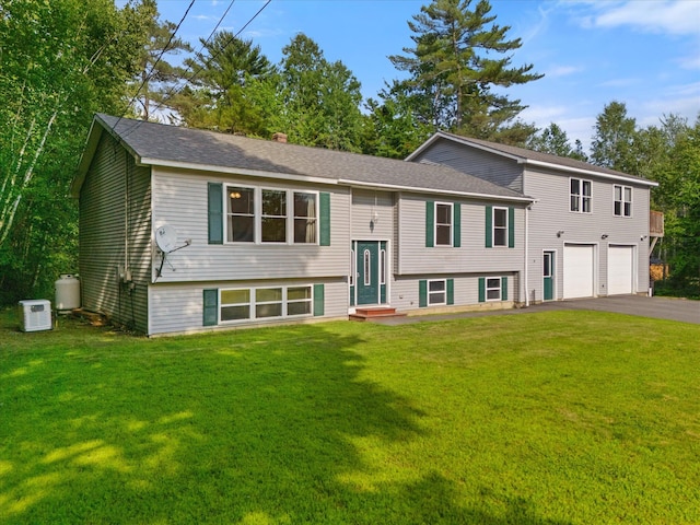 2 Bryer Heights Rd, Milford, ME 04461 - split foyer home with driveway, an attached garage, a front lawn, and entry steps