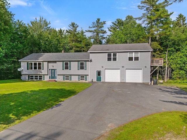 2 Bryer Heights Rd, Milford, ME 04461 - view of front of home featuring driveway, an attached garage, a front yard, view of scattered trees, and a shingled roof