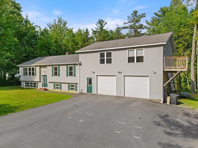 2 Bryer Heights Rd, Milford, ME 04461 - raised ranch featuring driveway, a garage, a front lawn, stairway, and a wooden deck