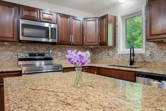 2 Bryer Heights Rd, Milford, ME 04461 - kitchen featuring stainless steel appliances, light stone counters, and decorative backsplash