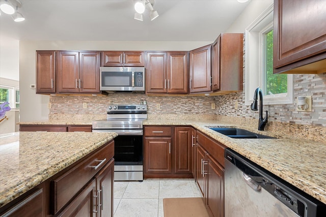 2 Bryer Heights Rd, Milford, ME 04461 - kitchen featuring stainless steel appliances, tasteful backsplash, light stone countertops, and a ceiling fan