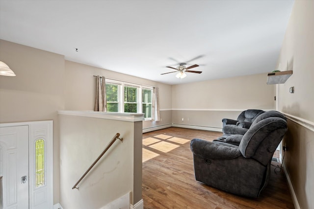 2 Bryer Heights Rd, Milford, ME 04461 - living area with light wood-style floors, ceiling fan, and a baseboard radiator