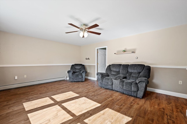 2 Bryer Heights Rd, Milford, ME 04461 - living area featuring a ceiling fan, wood finished floors, and a baseboard heating unit