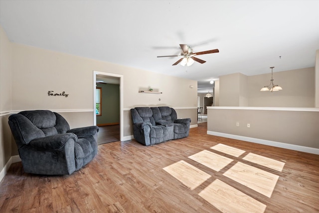 2 Bryer Heights Rd, Milford, ME 04461 - living room with ceiling fan, wood finished floors, and a chandelier
