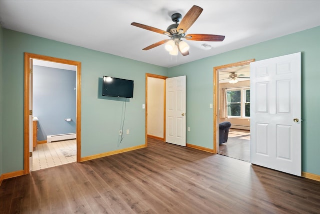 2 Bryer Heights Rd, Milford, ME 04461 - unfurnished bedroom featuring a baseboard radiator, wood finished floors, and a ceiling fan