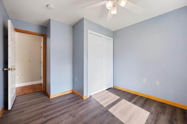 2 Bryer Heights Rd, Milford, ME 04461 - unfurnished bedroom featuring dark wood finished floors, a closet, and a ceiling fan
