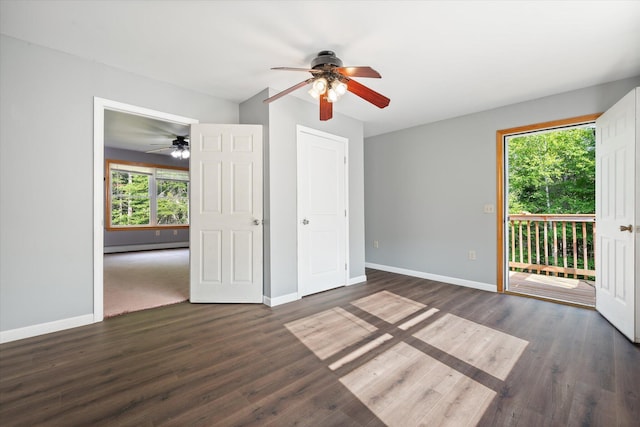 2 Bryer Heights Rd, Milford, ME 04461 - unfurnished bedroom featuring access to exterior, multiple windows, dark wood-style floors, and a baseboard heating unit