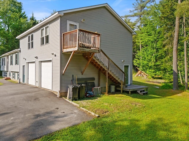 2 Bryer Heights Rd, Milford, ME 04461 - view of side of property with a garage, driveway, a wooden deck, a yard, and stairway