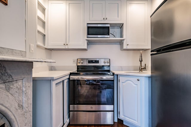 12 Deering St Unit 1, Portland, ME 04101 - kitchen with stainless steel appliances, light countertops, and white cabinets