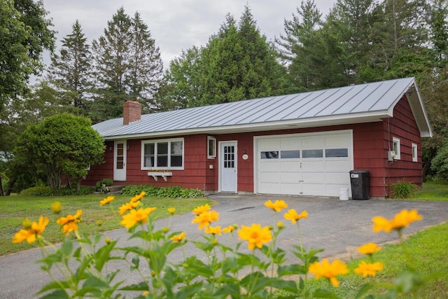 103 Mountain View Rd, Farmington, ME 04938 - single story home with a standing seam roof, a chimney, a metal roof, and a garage