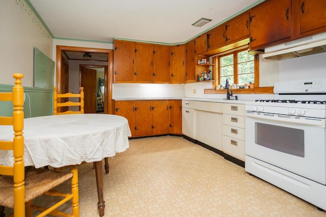 103 Mountain View Rd, Farmington, ME 04938 - kitchen featuring white range with gas cooktop, under cabinet range hood, light countertops, light flooring, and brown cabinets