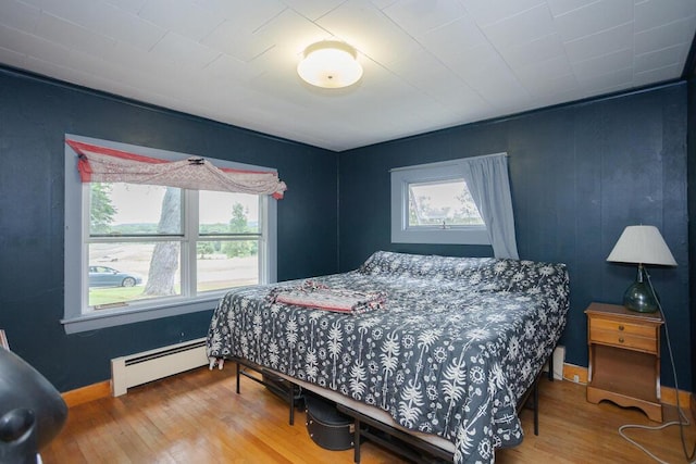 103 Mountain View Rd, Farmington, ME 04938 - bedroom with baseboard heating and wood finished floors